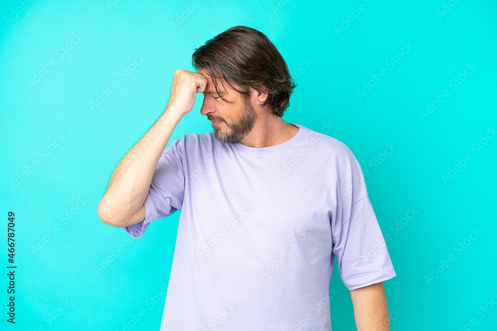 Senior dutch man isolated on blue background with headache Senior dutch man isolated on blue background with headache