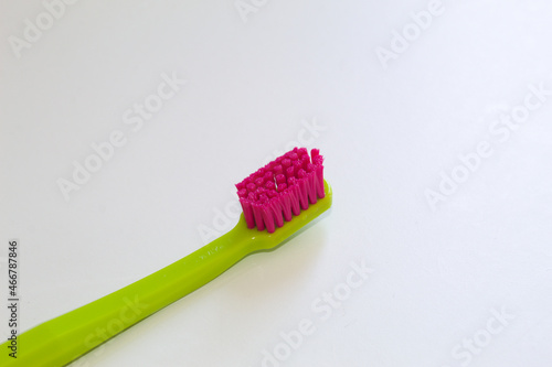 Colored toothbrush with white background.