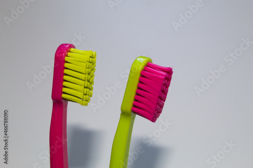 Colored toothbrush with white background.