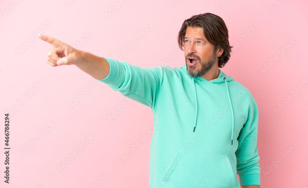 Senior dutch man isolated on pink background pointing away Senior dutch man isolated on pink background pointing away