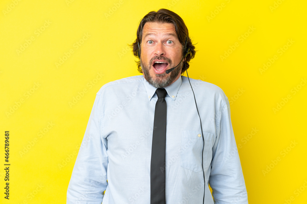 Telemarketer dutch man working with a headset isolated on yellow background with surprise facial expression Telemarketer dutch man working with a headset isolated on yellow background with surprise facial expression