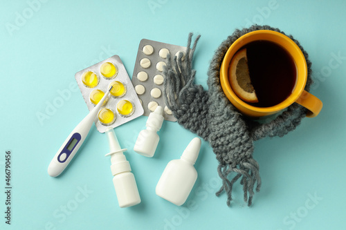 Flu treatment accessories on blue background, top view
