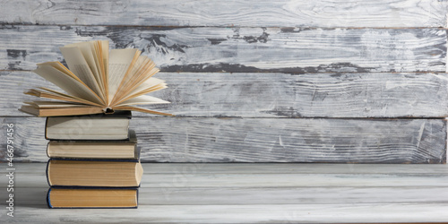 Open book, hardback books on wooden table. Back to school. Copy space