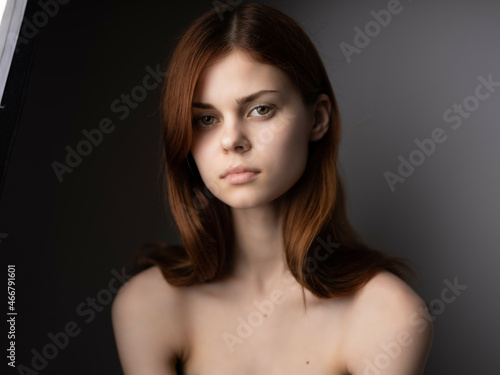 pretty woman red hair naked shoulders posing fashion dark background