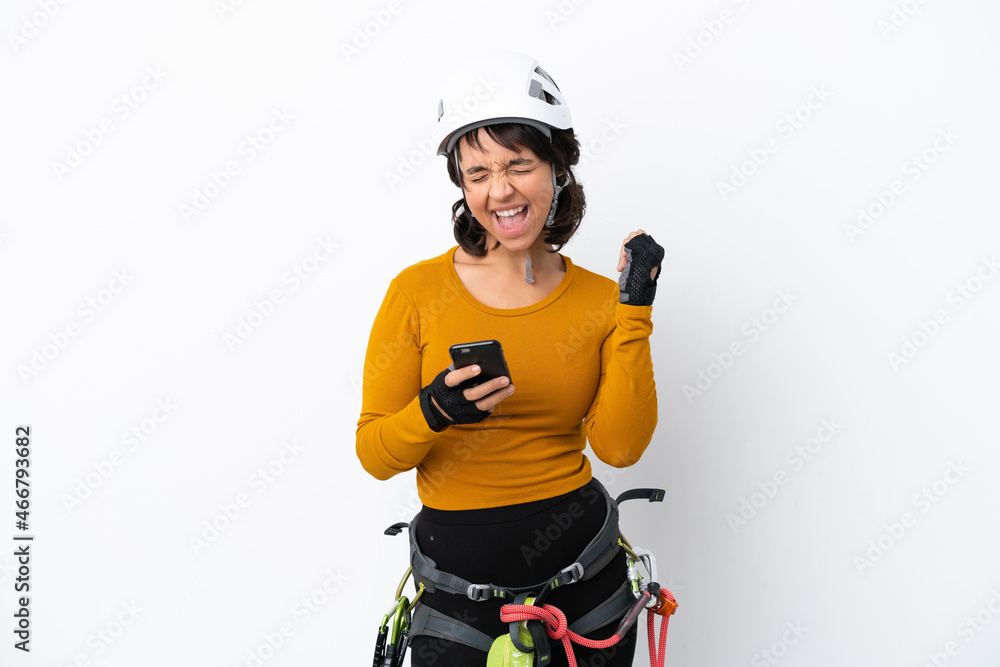 Young woman rock-climber woman isolated on white background with phone in victory position Young woman rock-climber woman isolated on white background with phone in victory position