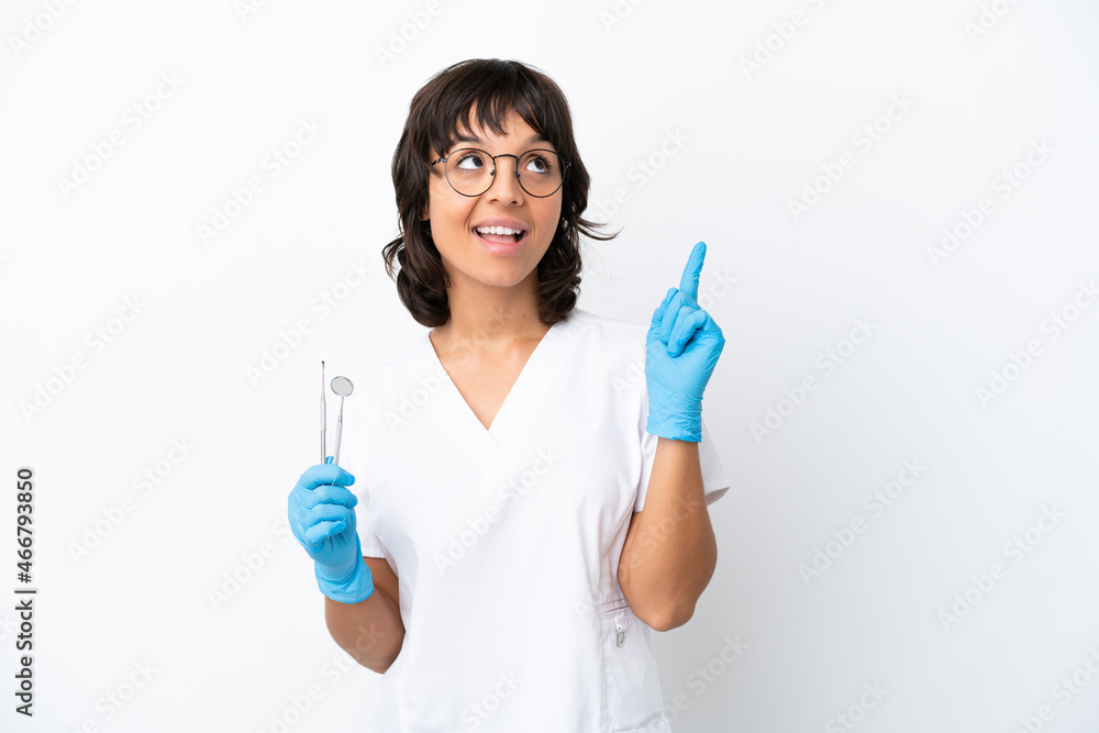 Young woman holding tools isolated on white background pointing up a great idea Young woman holding tools isolated on white background pointing up a great idea