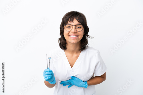 Young woman holding tools isolated on white background smiling a lot