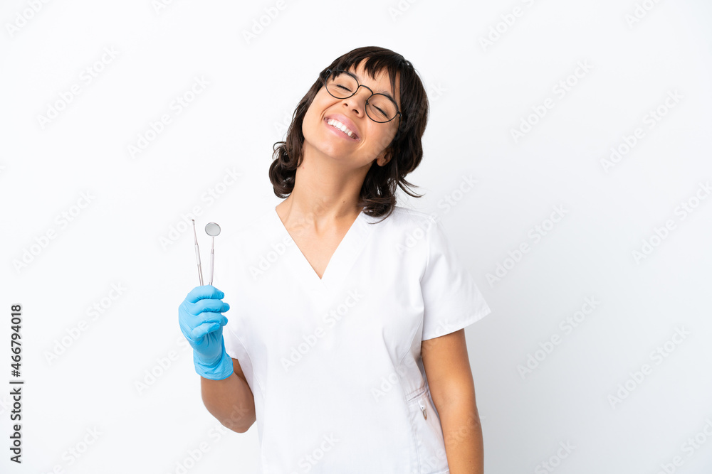 Young woman holding tools isolated on white background laughing Young woman holding tools isolated on white background laughing