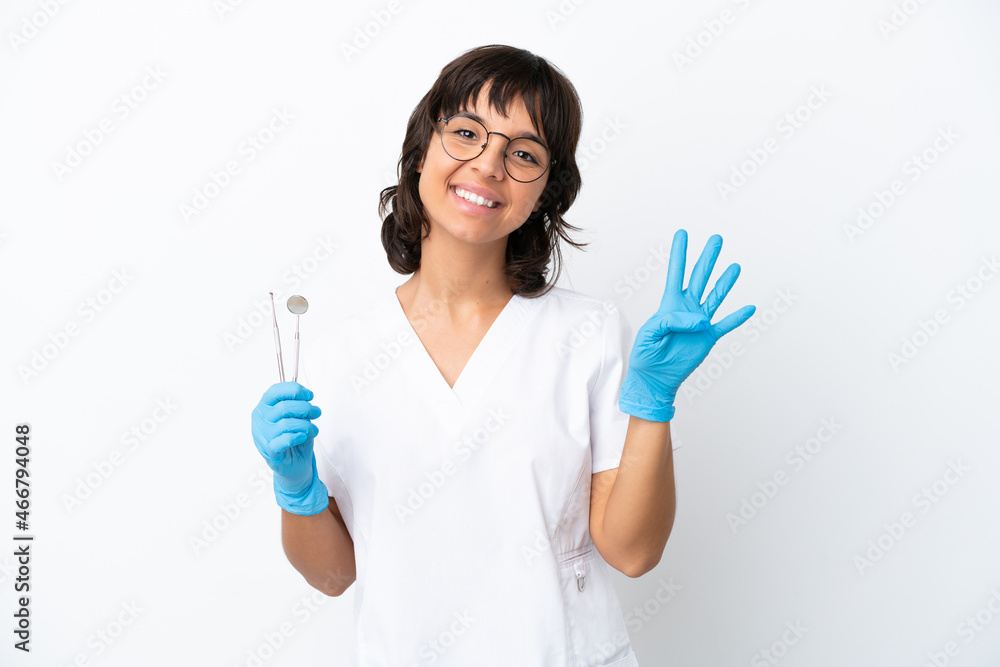 Young woman holding tools isolated on white background happy and counting four with fingers Young woman holding tools isolated on white background happy and counting four with fingers