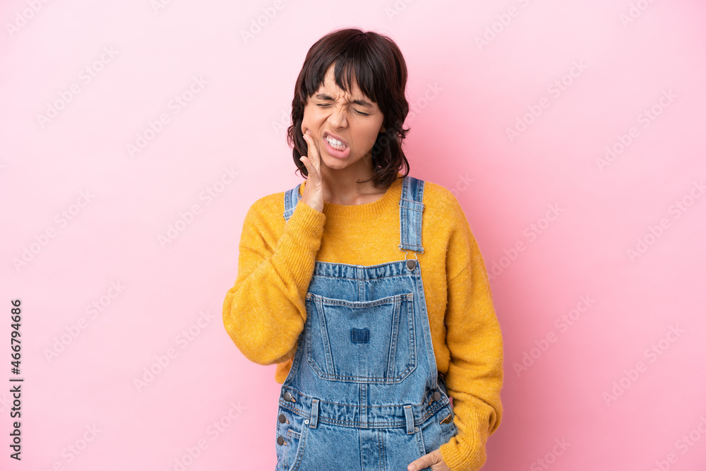 Young woman with overalls isolated background with toothache Young woman with overalls isolated background with toothache