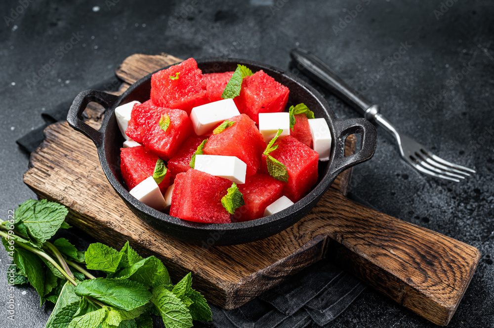 Healthy Organic Watermelon Salad with feta cheese. Black background. Top view