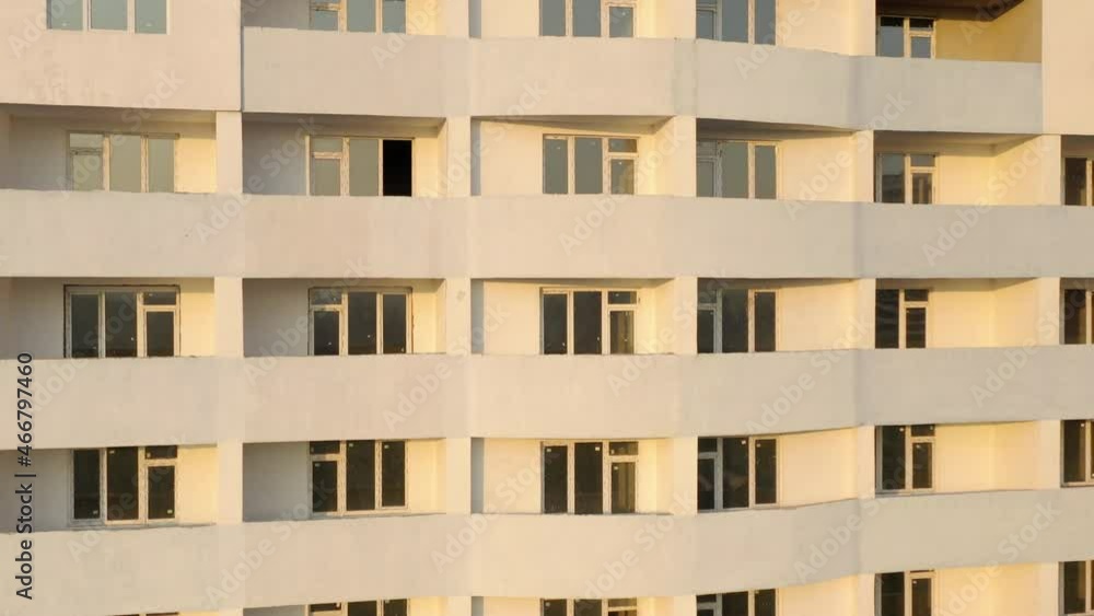 Aerial view of the facade of residential apartment buildings under construction. High-rise building with windows and balconies. Construction industry. Urbanization Aerial view of the facade of residential apartment buildings under construction. High-rise building with windows and balconies. Construction industry. Urbanization