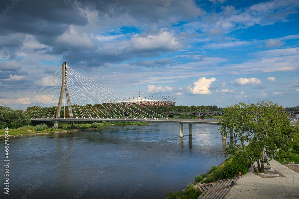 Warsaw - view of the Vistula river. In the background the Swietokrzyski Bridge and PGE Narodowy Stadium - obrazy, fototapety, plakaty 
