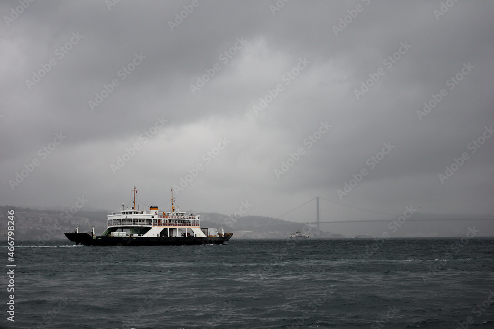 passenger ferry crosses the Bosporus strait in Istanbul, Turkey in stormy and rainy day