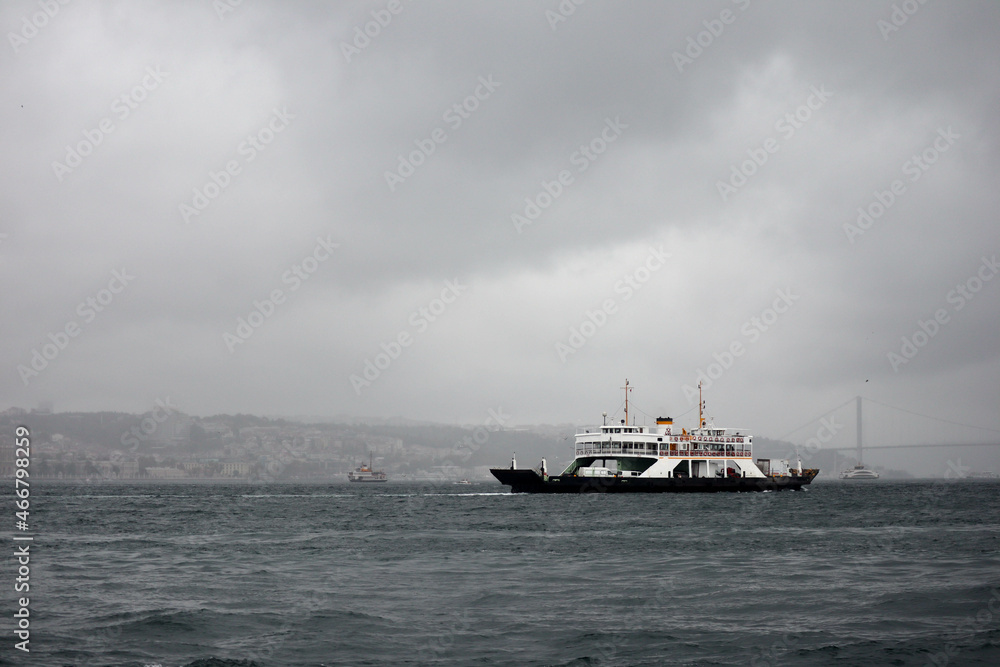 passenger ferry crosses the Bosporus strait in Istanbul, Turkey in stormy and rainy day