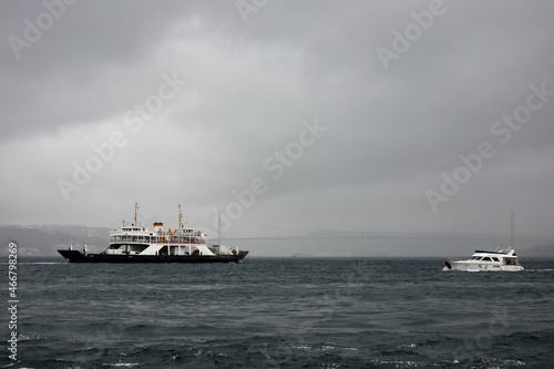 passenger ferry crosses the Bosporus strait in Istanbul  Turkey in stormy and rainy day