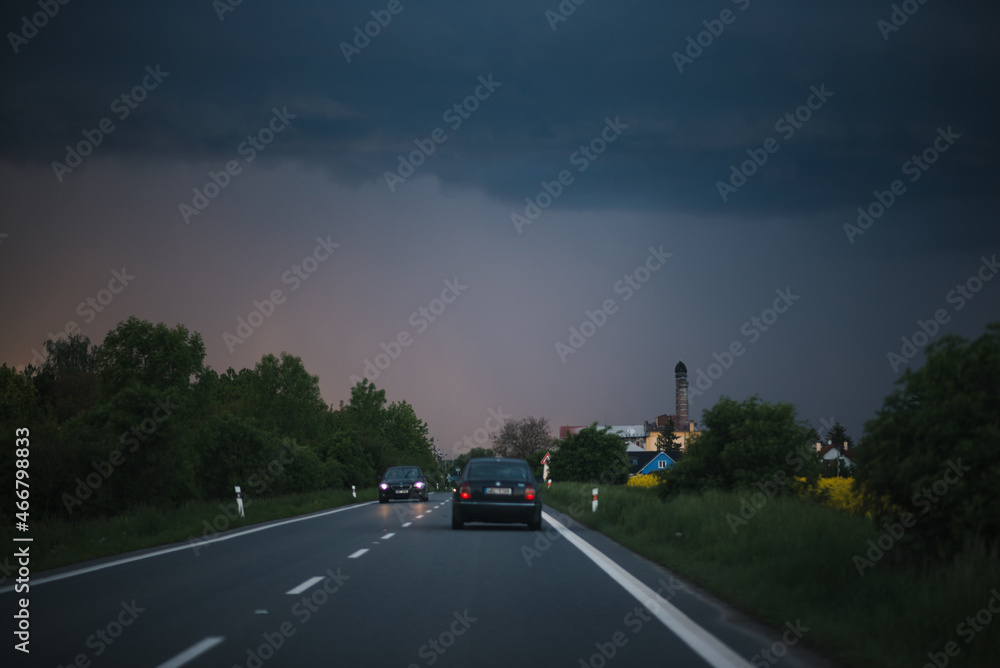 View of a car on the highway at sunset. light traffic, on an empty expressway.