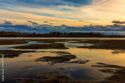 autumn landscape sandy beach, evening sunset on the river bank