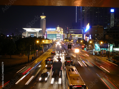 A very narrow path high up in the Chinese Mountains with blue sky and some clouds and a steep canyon on the right side