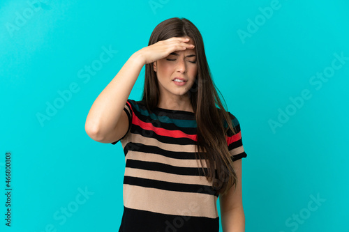 Teenager Brazilian girl over isolated blue background with headache