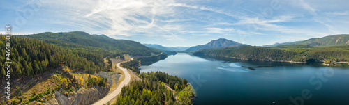 Aerial panoramic view of a scenic highway around mountains. East Kootenay, British Columbia, Canada.