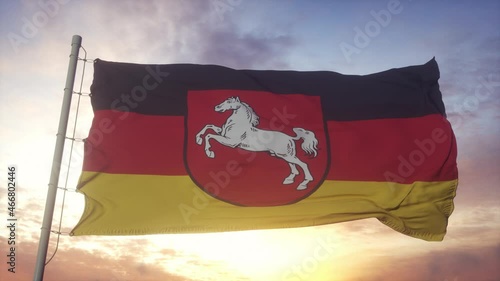 Lower Saxony flag, Germany, waving in the wind, sky and sun background