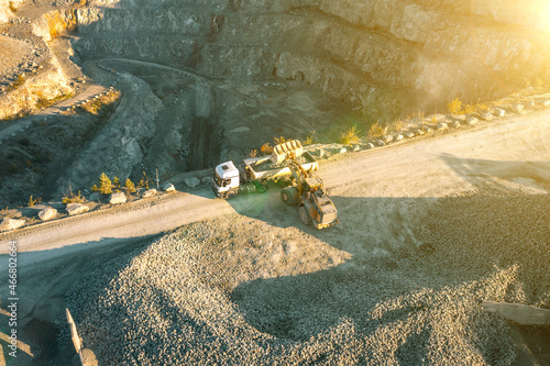 Loading crushed stone into the body of a dump truck, stone quarry photo