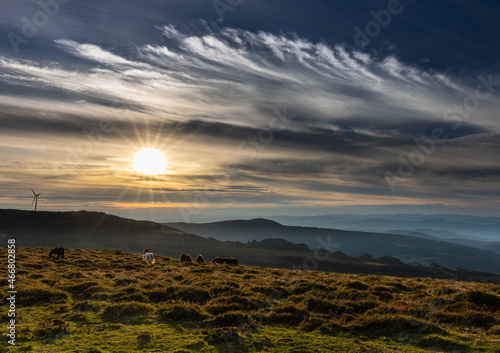 Day and Night with a crescent moon at the end of summer in the mountains of Asturias, with horses and a sunset of color!