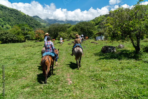 Tamesis, Antioquia, Colombia. June 19, 2020: Horseback riding in the field with beautiful blue sky. © camaralucida1