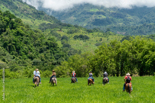 Tamesis, Antioquia, Colombia. June 19, 2020: Horseback riding in the field with beautiful blue sky. photo