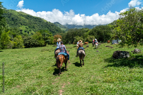 Tamesis, Antioquia, Colombia. June 19, 2020: Horseback riding in the field with beautiful blue sky. © camaralucida1