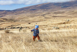 One year old boy walks on a mountain plateau