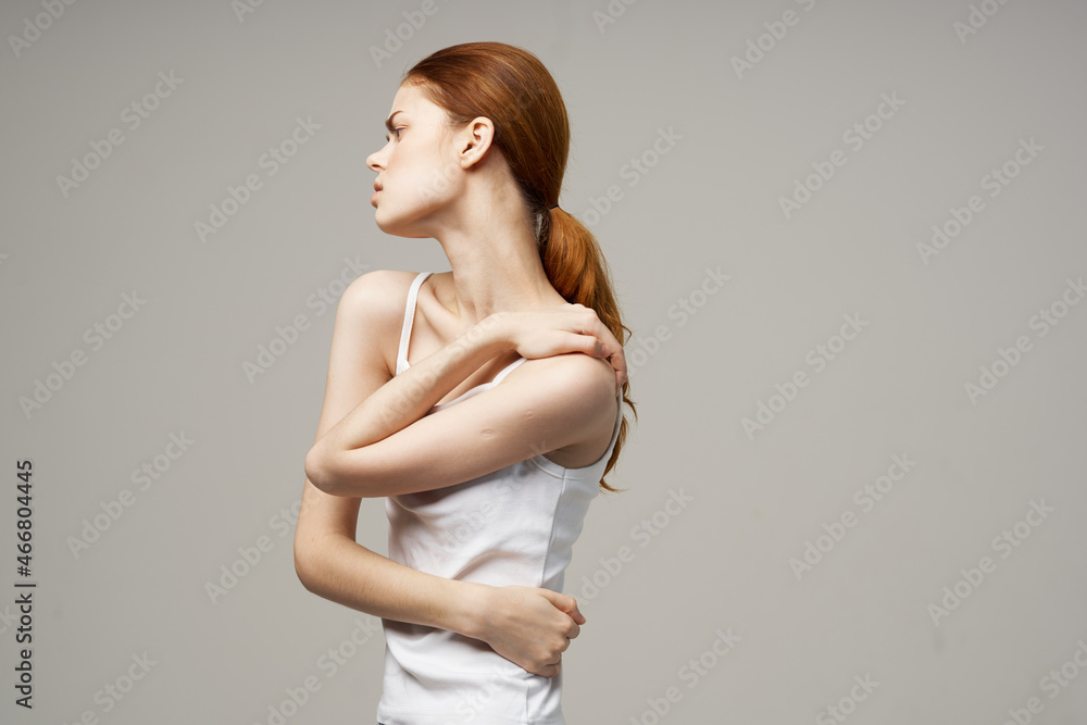 Fototapeta premium disgruntled woman rheumatism pain in the neck health problems studio treatment