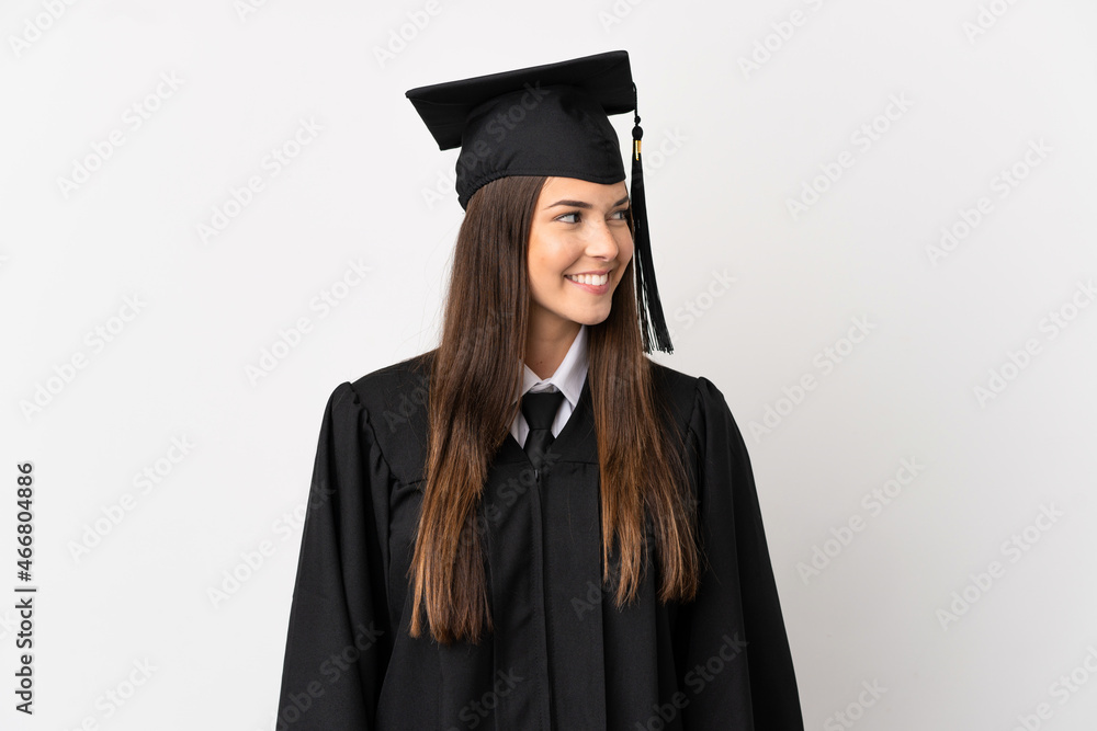 Teenager Brazilian university graduate over isolated white background looking side Teenager Brazilian university graduate over isolated white background looking side