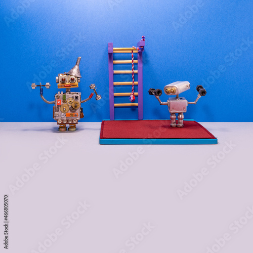 Two robotic athletes in the gym. Robotics weightlifters holding a dumbbells. Sport fitness, weightlifting and power lifting athletics workouts. blue gray background