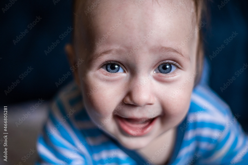 A smiling toothless kid in a striped blouse laughs, face close-up. . High quality photo A smiling toothless kid in a striped blouse laughs, face close-up. . High quality photo