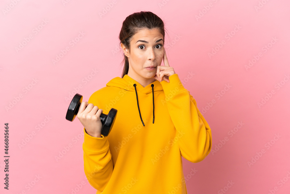 Young sport girl making weightlifting over isolated pink background thinking an idea Young sport girl making weightlifting over isolated pink background thinking an idea