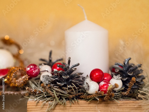 Christmas decoration. White candle, cones, red and white balls