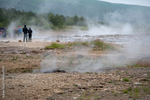 Landscape of tourists and steam coming off of Geysir Golden Circle Iceland