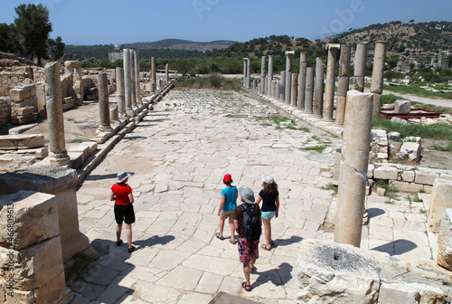 Tourists at colonnade street and ruins in Patara, Antalya, Turkey. Patara was a flourishing maritime and commercial city. photo