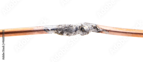 Two copper wires are soldered together isolated on a white background.Soldering wires with tin photo