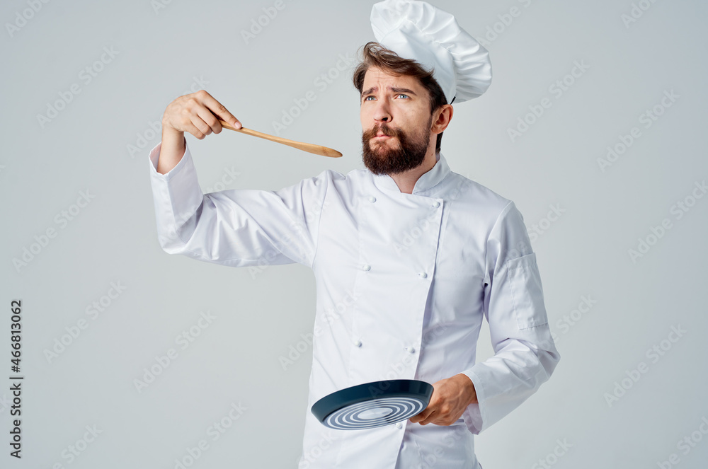 a man in a chef's uniform restaurant provision of services light background a man in a chef's uniform restaurant provision of services light background