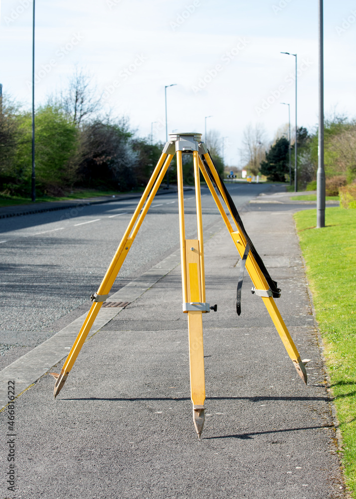 Heavy wooden tripod set by site engineer above control point before fitting surveying equipment to it Heavy wooden tripod set by site engineer above control point before fitting surveying equipment to it