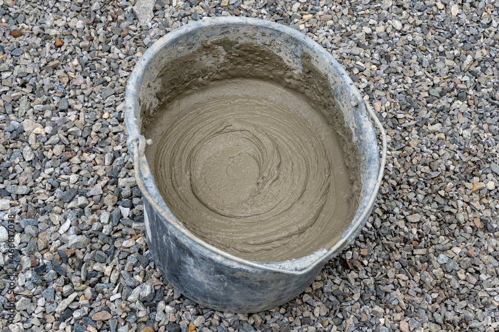 Bucket with construction putty. Cement bucket for construction at a construction site.