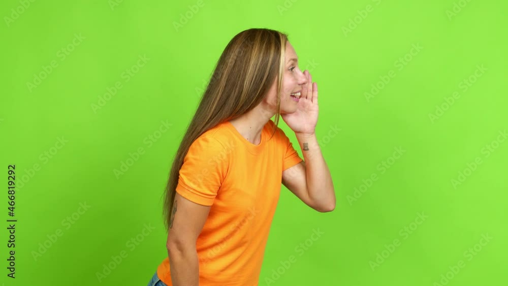 Young blonde girl shouting to the lateral and announcing something over isolated background. Green screen chroma key Young blonde girl shouting to the lateral and announcing something over isolated background. Green screen chroma key