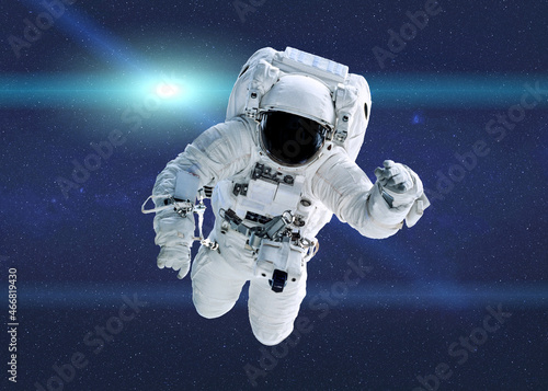 Space astronaut in outer space with lens flare. Science fiction wallpeper. Elements of this illustration were furnished by NASA. photo