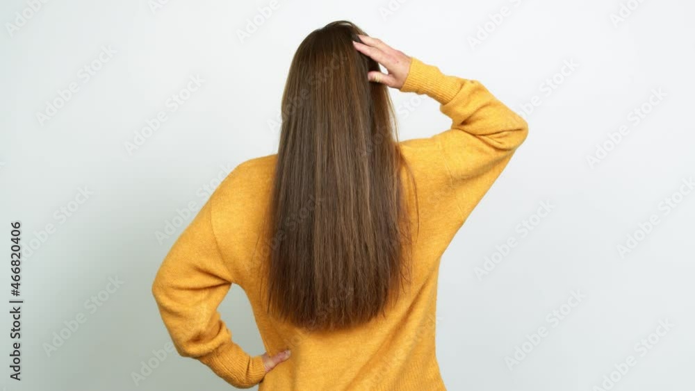 Young blonde girl on back position looking back while scratching head over isolated background Young blonde girl on back position looking back while scratching head over isolated background