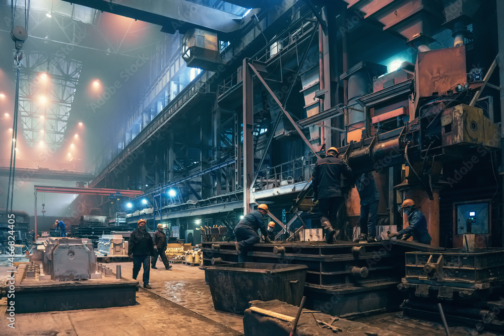 Heavy industry, steel mill foundry industrial metallurgical plant workshop interior, steelmaking manufacturing with many workers.