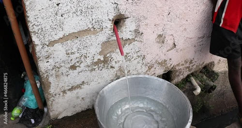 City water supply poor slums of Accra Ghana. No city or village infrastructure, no running water or sewer system. Poverty areas of Accra rely on community borehole and pumps to get water for all uses. photo