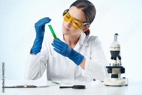 female doctor sitting at the table microscope research isolated background